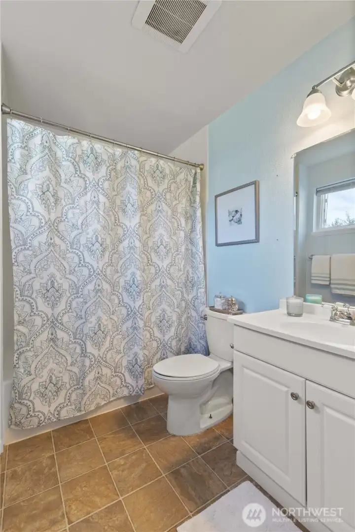 Private bath in the primary suite—stylish and well-maintained.