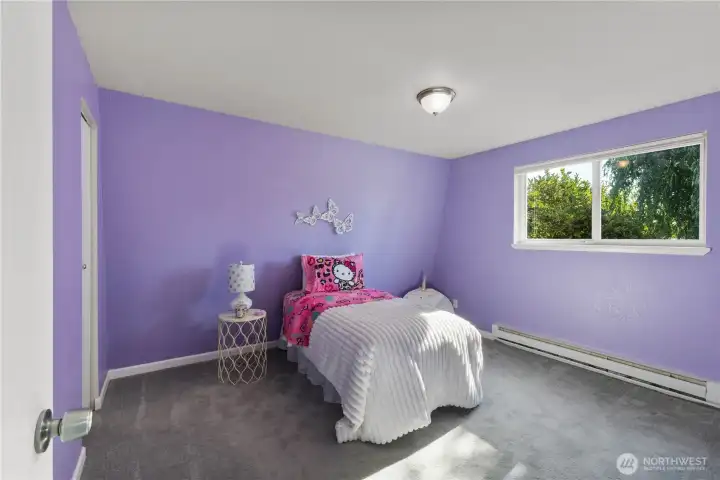 Cheerful bedroom with accent wall and lots of personality—great for kids or creative workspace.