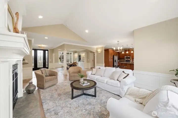 Living room looking toward open formal dining area and kitchen with eating space and bar