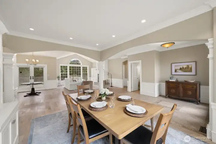 Formal dining area with open living room, less formal dining area off kitchen and half-bath.