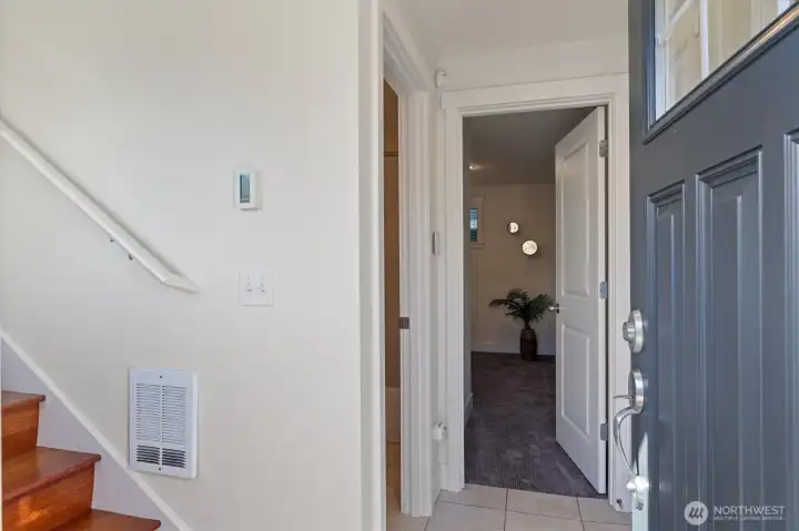 Just past the front door is a coat closet and garage entrance