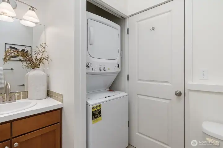 Full-size stackable washer and dryer is located in the main hall bathroom