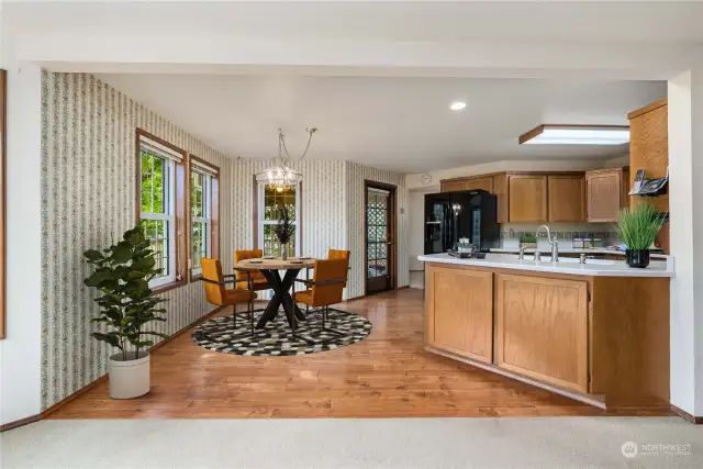 Virtually staged eat-in kitchen area.