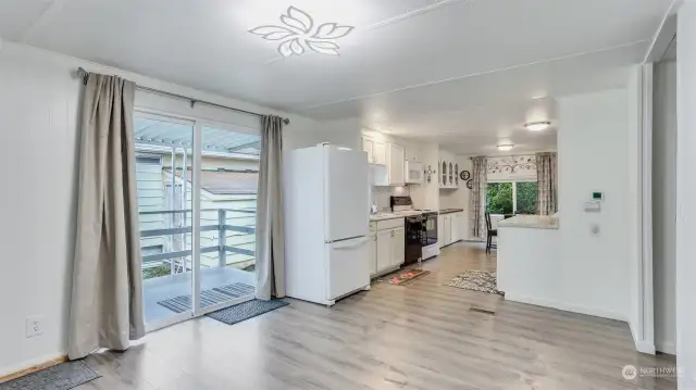 Enjoy this informal dining space just steps from the kitchen and the back patio, ideal for year round entertaining.