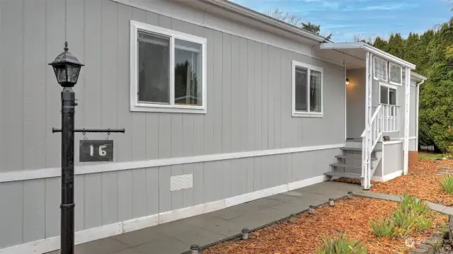 Newer exterior paint and beautifully paved walkway greets you as you arrive.