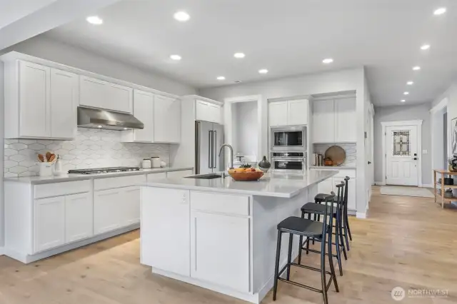 Kitchen with oversized island Kitchen Aid appliances and Bonus Stainless Refrigerator