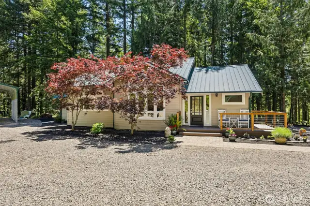 Main Home - Front view with large covered RV parking to the left.