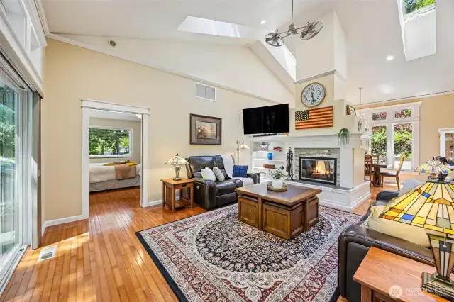 Main Home - Living room with vaulted ceilings, see through fireplace.