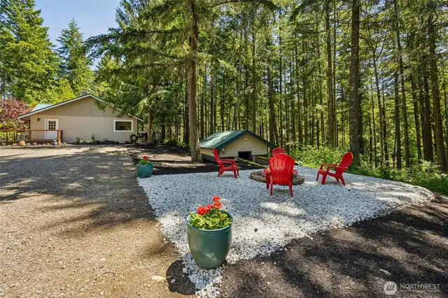 Fire pit area. Pump/well house pictured to the right just below grade.