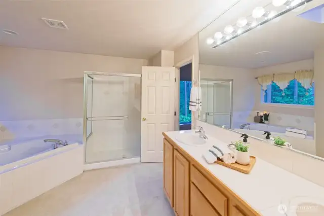 5-piece primary ensuite bathroom with maple cabinets and tile countertops.