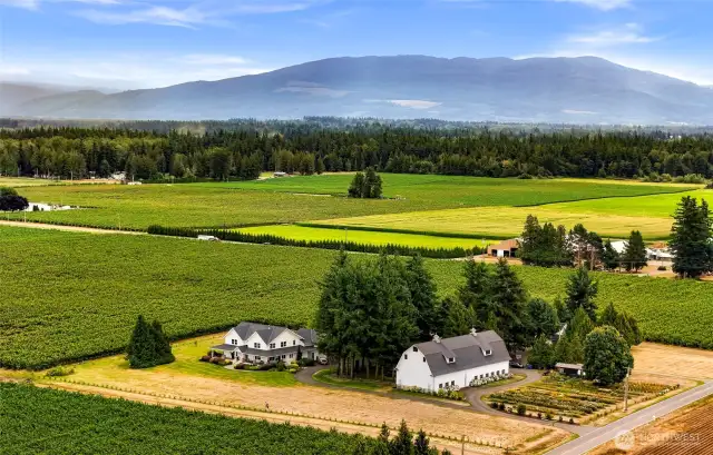 Off the quiet road and set just right above the cultivated fields amidst the prettiest setting imagined