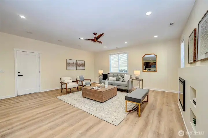 Family Room with ceiling fan and electric fireplace