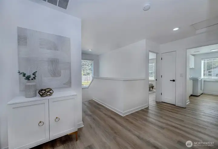 2nd floor hallway at the top of the stairs. Leads to bedrooms and laundry room