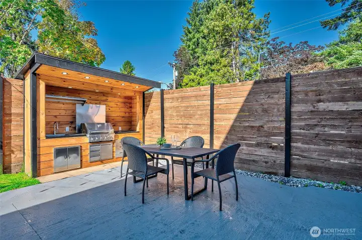 Built-in BBQ area with prep sink and countertop