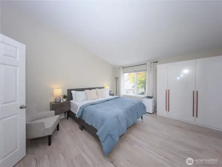 The spacious primary suite features vaulted ceilings, dual closets, and a remodeled bath