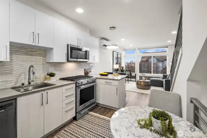 Contemporary kitchen designs with quartz counters, designer backsplash & subtle two-toned cabinetry.