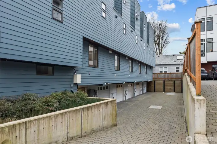 Access private garage from the back of the building.  Guest bedroom window above garage.