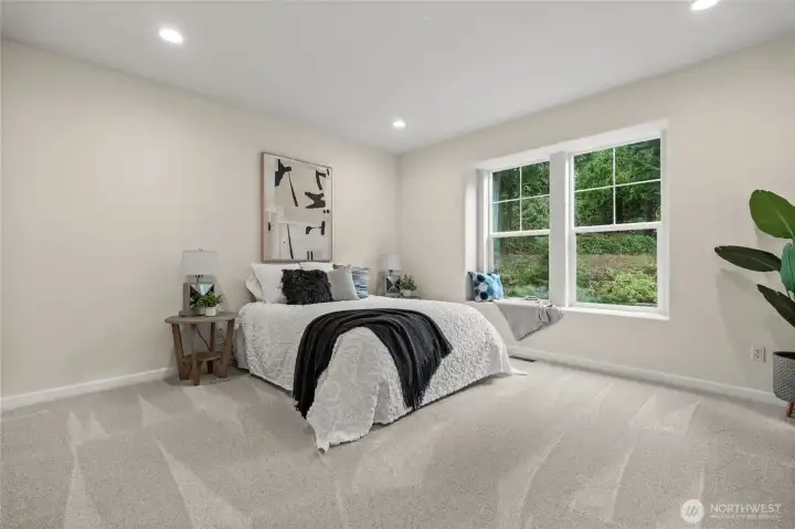 In this secondary guest suite, invite yourself to a "home away from home" experience, with lots of space and some beautiful backyard views.