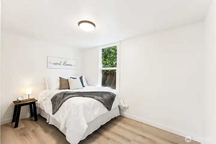 Cozy bedroom with natural light and brand new flooring. This is a full size bed. Seller had a queen bed in this room at one time.