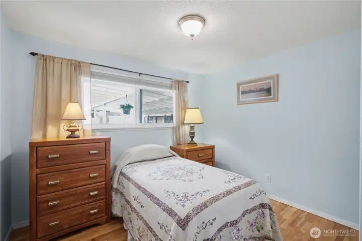 Bright and cozy third bedroom with abundant natural light offering a comfortable and inviting space with flexibility for a variety of uses.