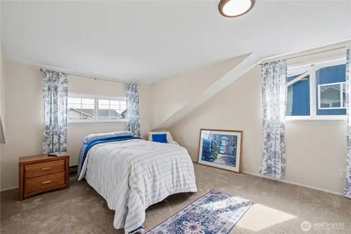 Sun drenched bonus space with elevated ceiling lines, offering versatility for a media room, guest suite, or home office.