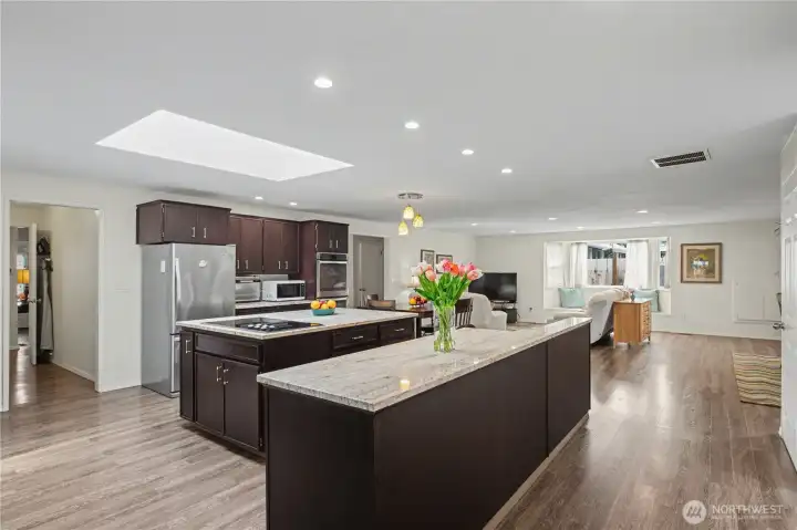 Oversized island and skylight above fille the space with natural light while enhancing functionality and warmth.