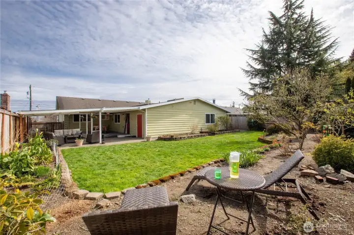 Outdoor setting patio space and open green areas, creating a peaceful retreat for gatherings, play, or quiet relaxation.