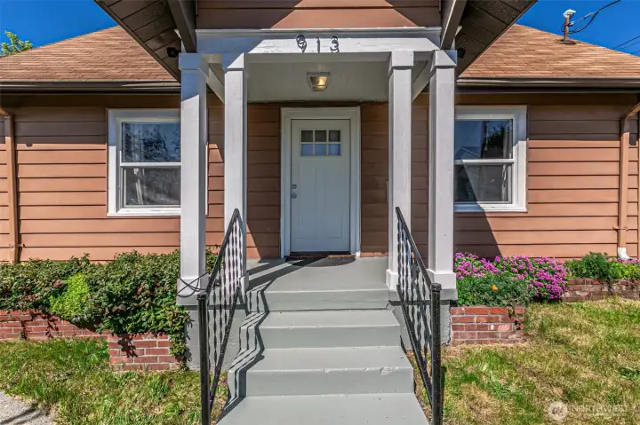 Welcoming front porch greets you as you enter this darling home.