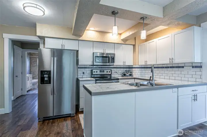 View of kitchen and adjoining laundry room for convenience.