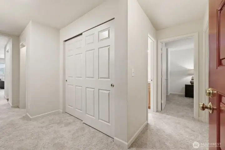 Foyer with storage, leading to main living areas to the left & bedrooms to the right.