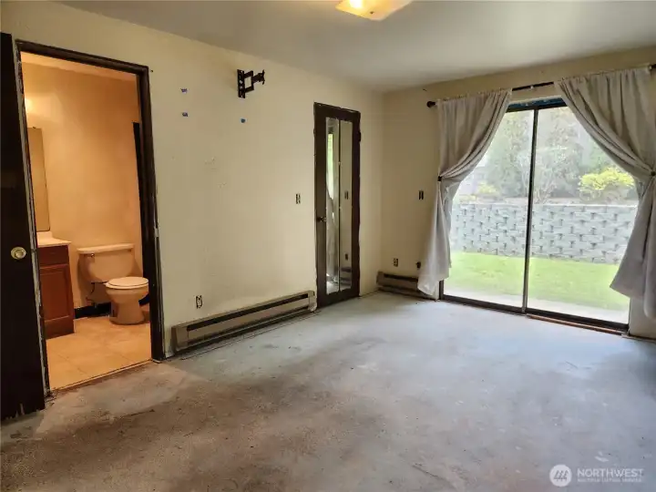 Primary bedroom with slider to the patio and direct access to the bathroom