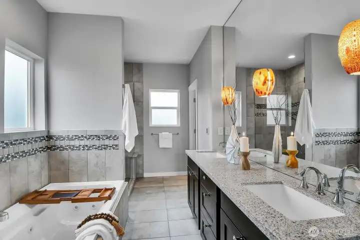 This 5-piece bath is accessed through the primary bedroom. This 5-piece bath is accessed through the primary bedroom.