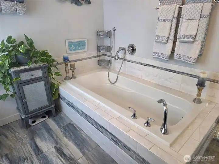 Extra large soaking tub in the primary bedroom suite