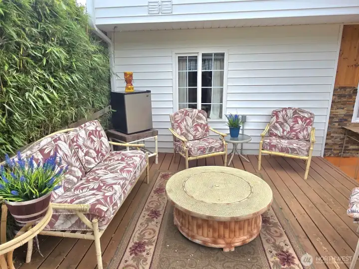 seating area under the gazebo and bordered with potted bamboo for privacy