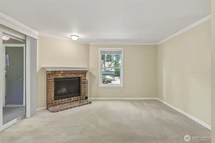 Living room with wood burning fireplace.