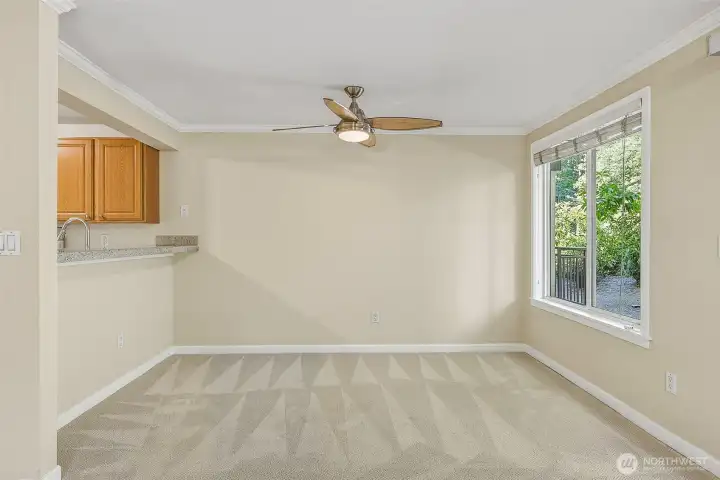 Dining room with ceiling fan. Kitchen counter could accommodate up to four stools.