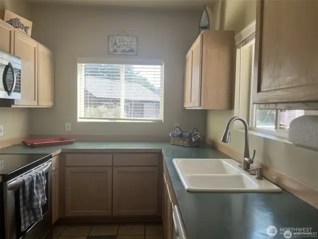 Galley kitchen with room for expansion. You can use the kitchen window to serve food outside to the deck.