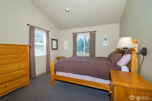 2nd large bedroom with vaulted ceilings and large closet.