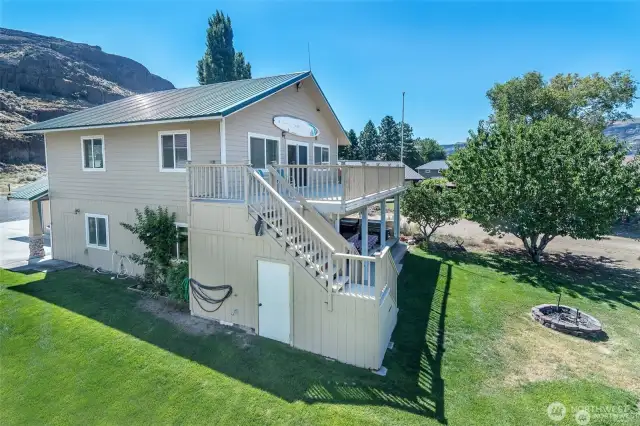 Side of house highlighting the storage area under the stairs.