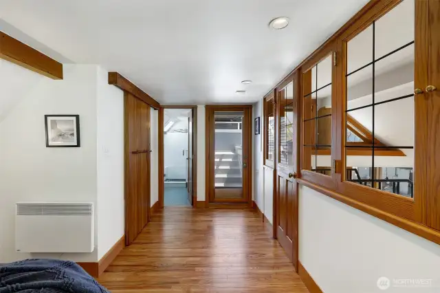 The primary bedroom has a has a deep closet which is the first door on the left in this photo.  The three quarter bathroom is straight ahead and the door next to it leads to your rooftop deck.