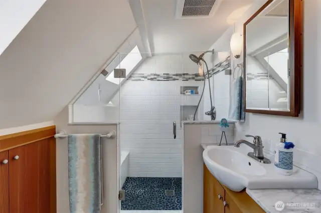The cabinet in the left of this photo is HUGE with SO MUCH STORAGE.  We particularly love the window inside the shower for natural light.