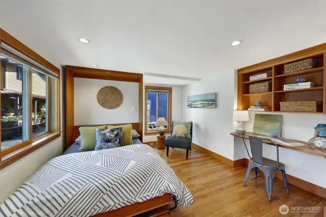 Back down to the main level, this is the second bedroom which can also be an office.  The murphy bed is convenient and there is a closet to the right of the live edge built in desk.