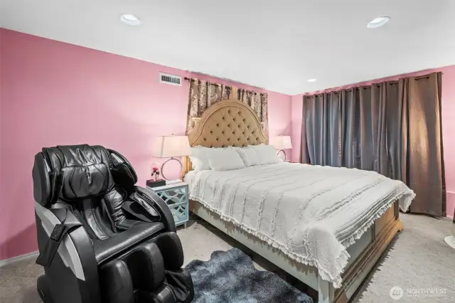Lower floor primary with 2 closets left of chair