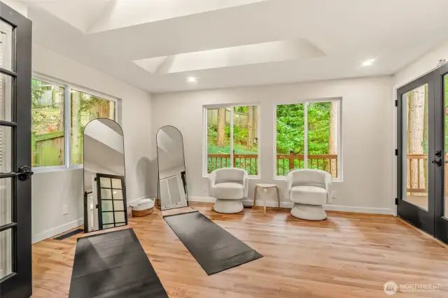 GREAT view of the bonus room off of the primary suite.  Fully secluded back yard. French doors lead to the deck is to the right. Hardwood floors recently re finished!
