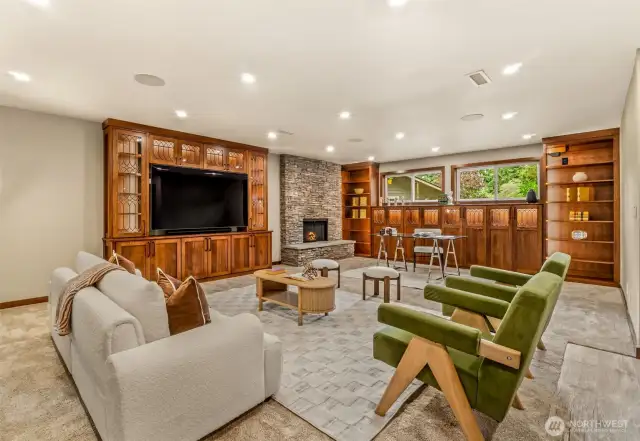 Downstairs w/ CUSTOM lighted cabinets, wood burning fireplace.  Massive TV STAYS!