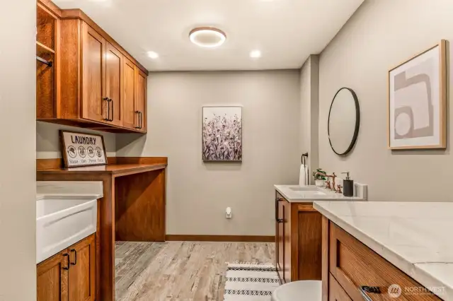 Utility room w/ NEW cabinets, floors, paint, trim and sink!
