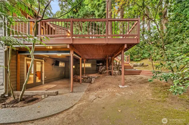 Massive deck showing exterior side of the French doors, this area has retractable screens & infrared heating! TV stays!