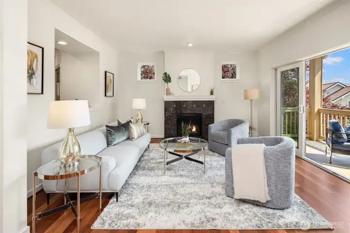 One level up is the main level of the home, featuring a living room, kitchen, den/office, and powder room. The living room has great natural light, newly refinished cherry hardwood floorings, a gas fireplace, and access to a terrific covered deck.