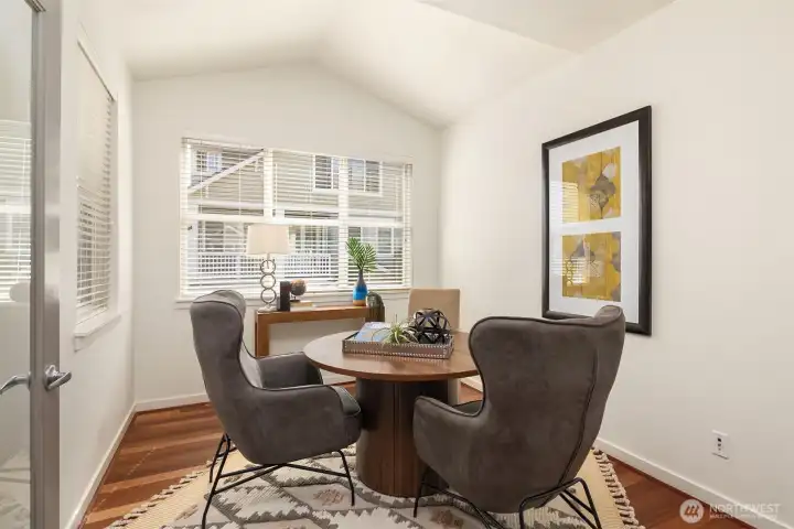 Before heading to the stairs leading to the upper level, you'll come to this den/office with vaulted ceilings and double-door glass entry.