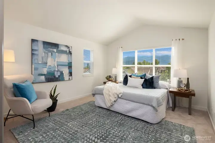 The primary suite has vaulted ceilings, new carpet, and views of the Issaquah Alps. This is a King-sized bed.
